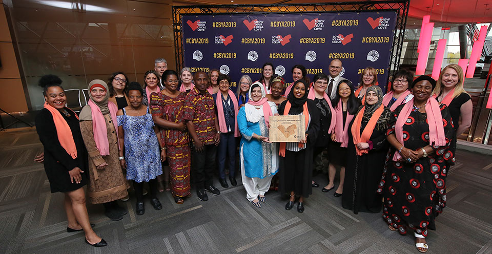 Award photo of the many women involved with MVC